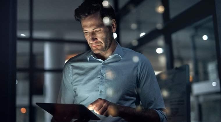 Business man, working and tablet of a employee doing digital, web and internet strategy planning. Corporate businessman and tech worker in the dark using technology to work on online and IT analytics