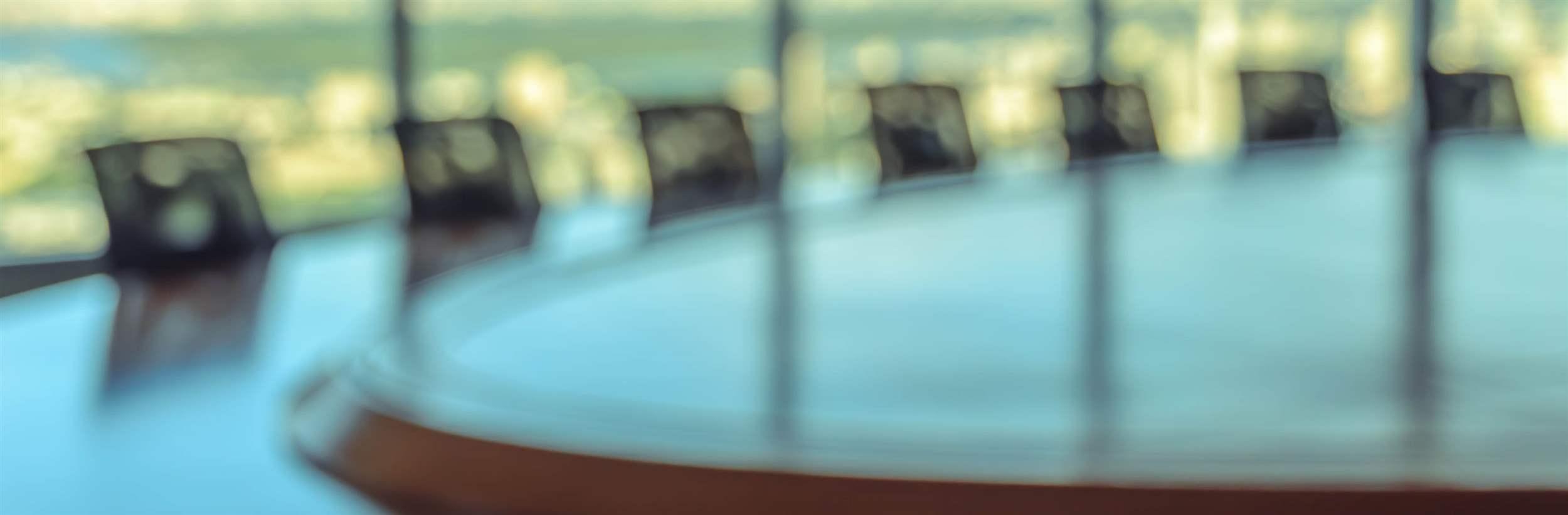 Blur image of empty boardroom with window cityscape background. Business concept