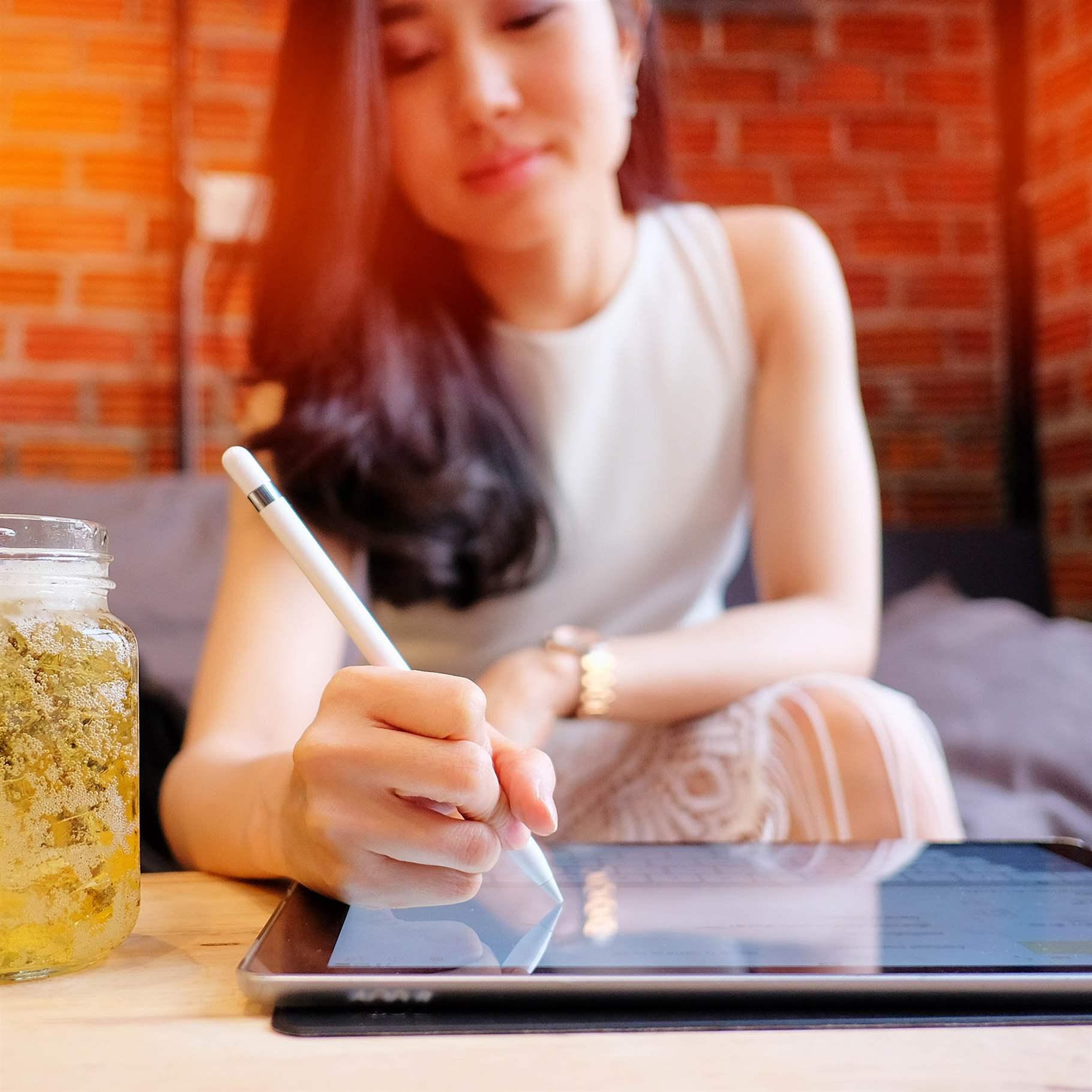 close up of a business woman analyzing business graphs on digital tablet