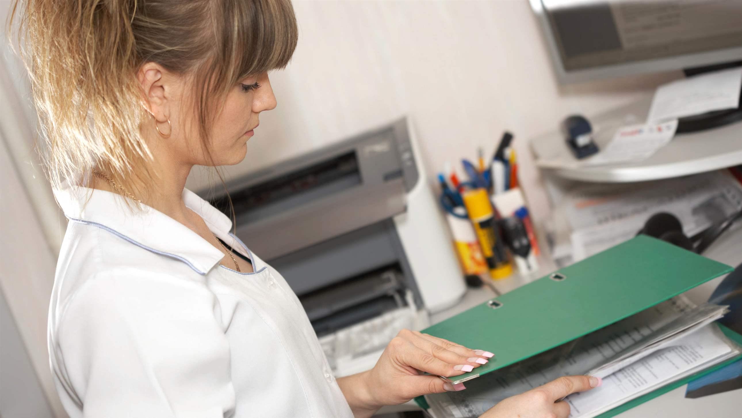 The woman the doctor looks the documents in hospital