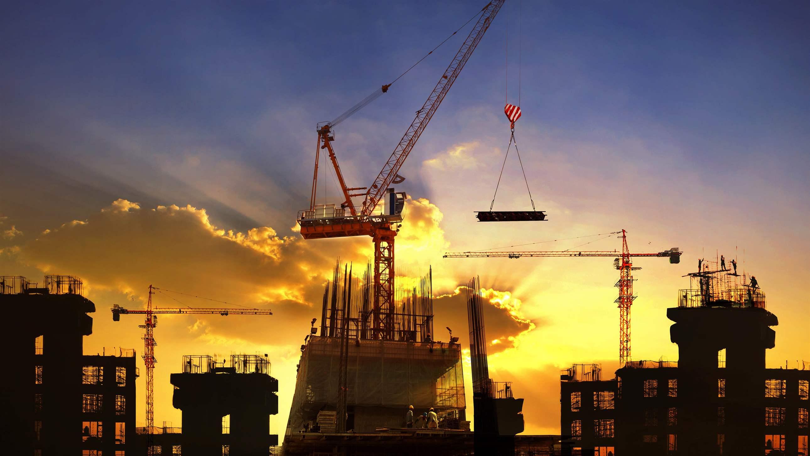 big crane and building construction against beautiful dusky sky use for construction industry and engineering