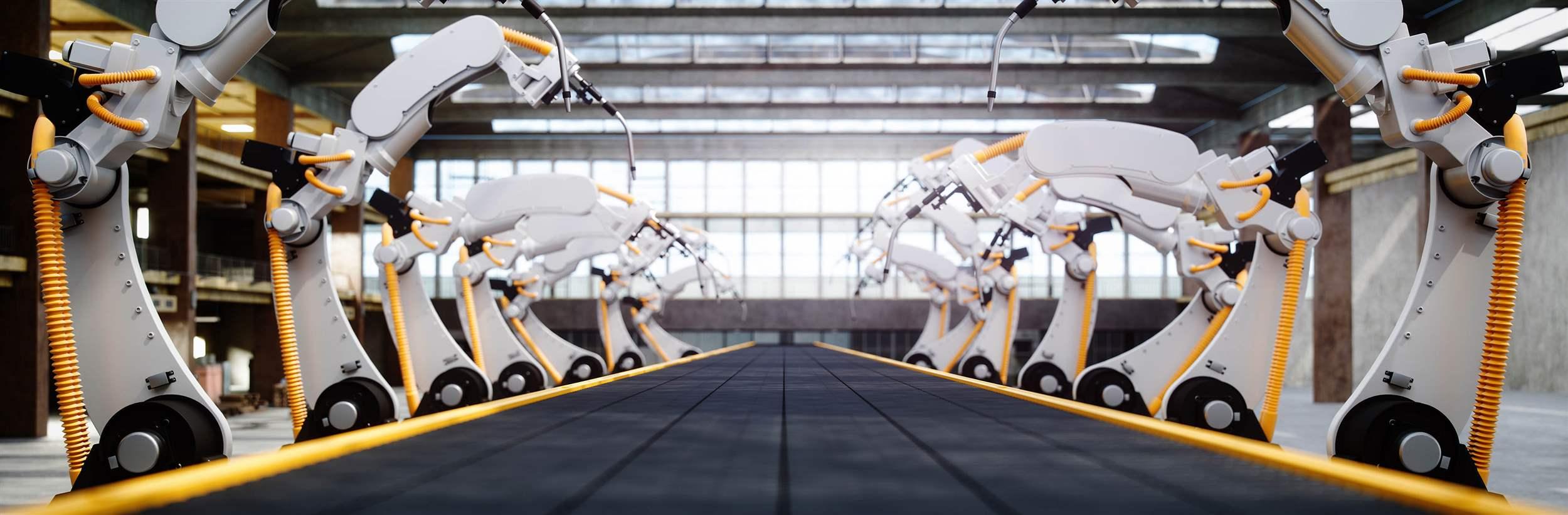 Interior of a modern automated factory with robotic arms and conveyor belt.