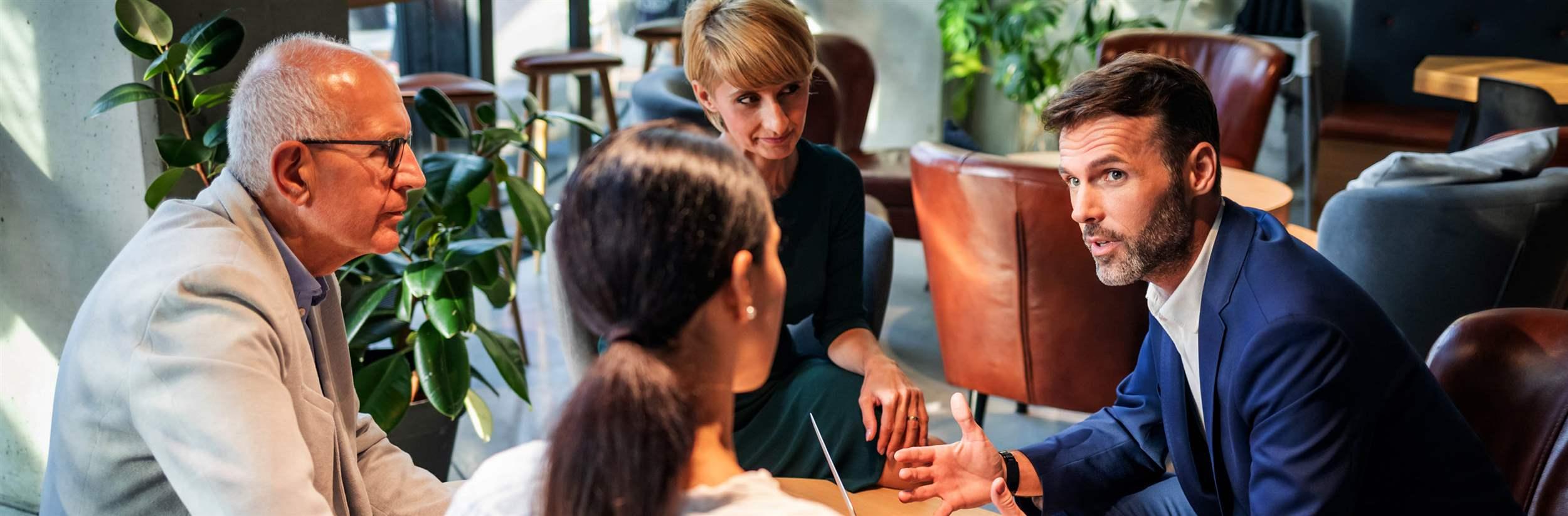 Group of business people meeting during coffee time