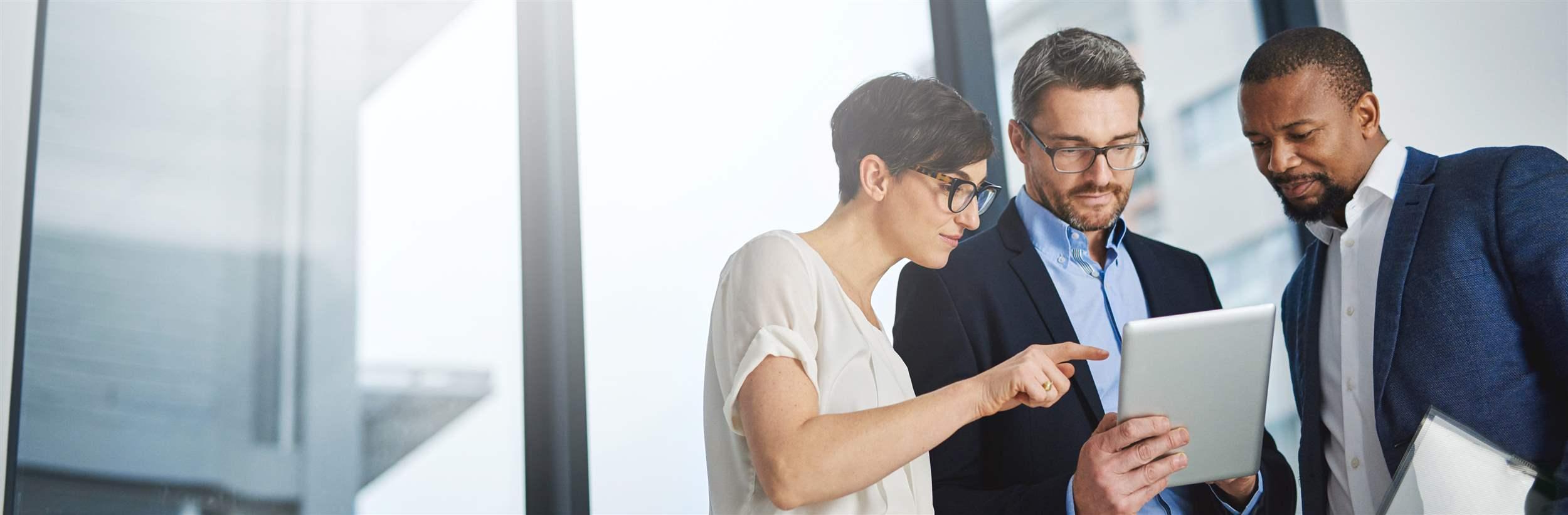 Colleagues using a digital tablet together at work