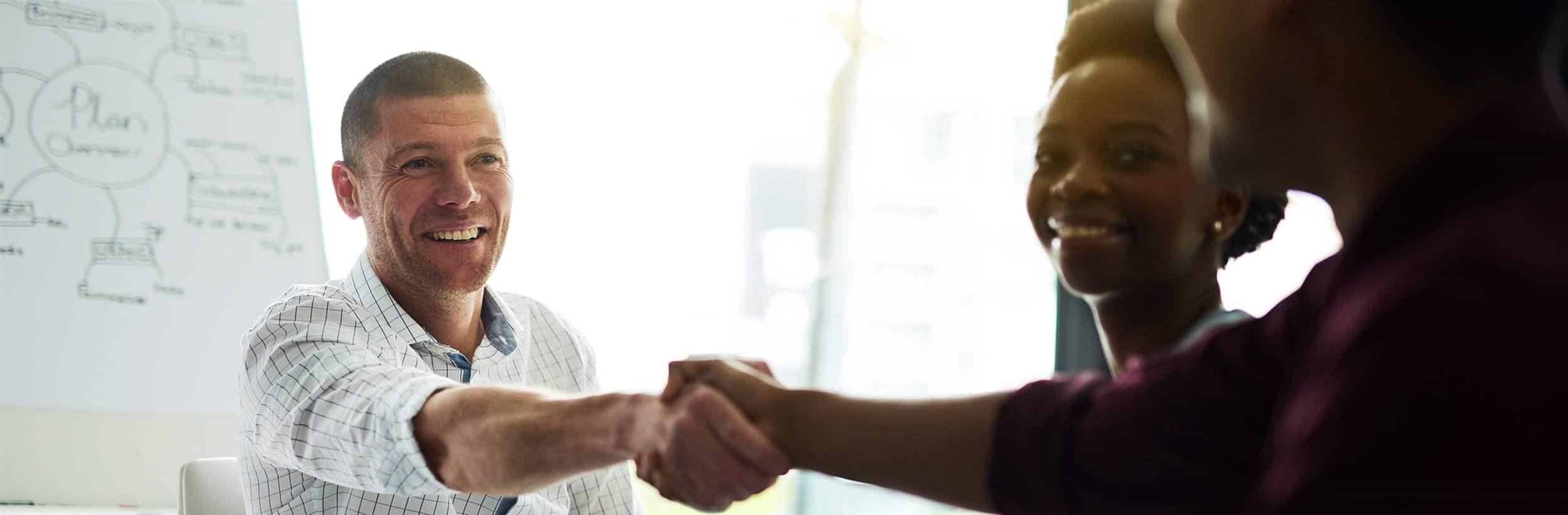 Cropped shot of businesspeople shaking hands during a meeting in an office