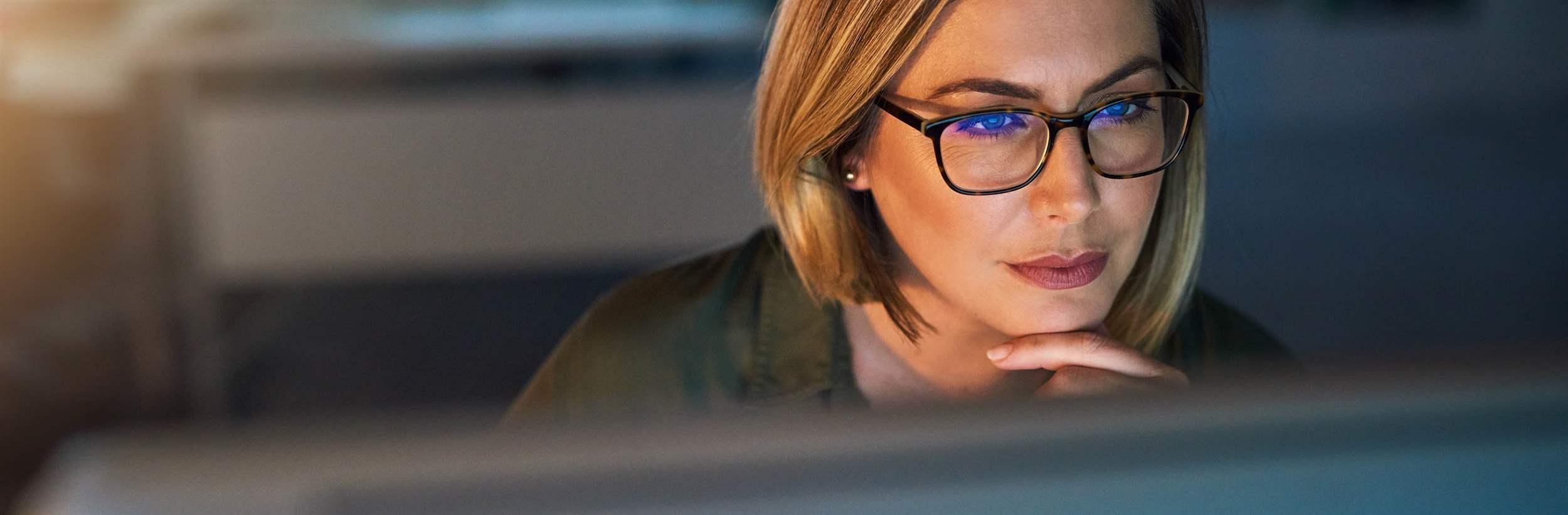 Shot of a young businesswoman working late on a computer in an office