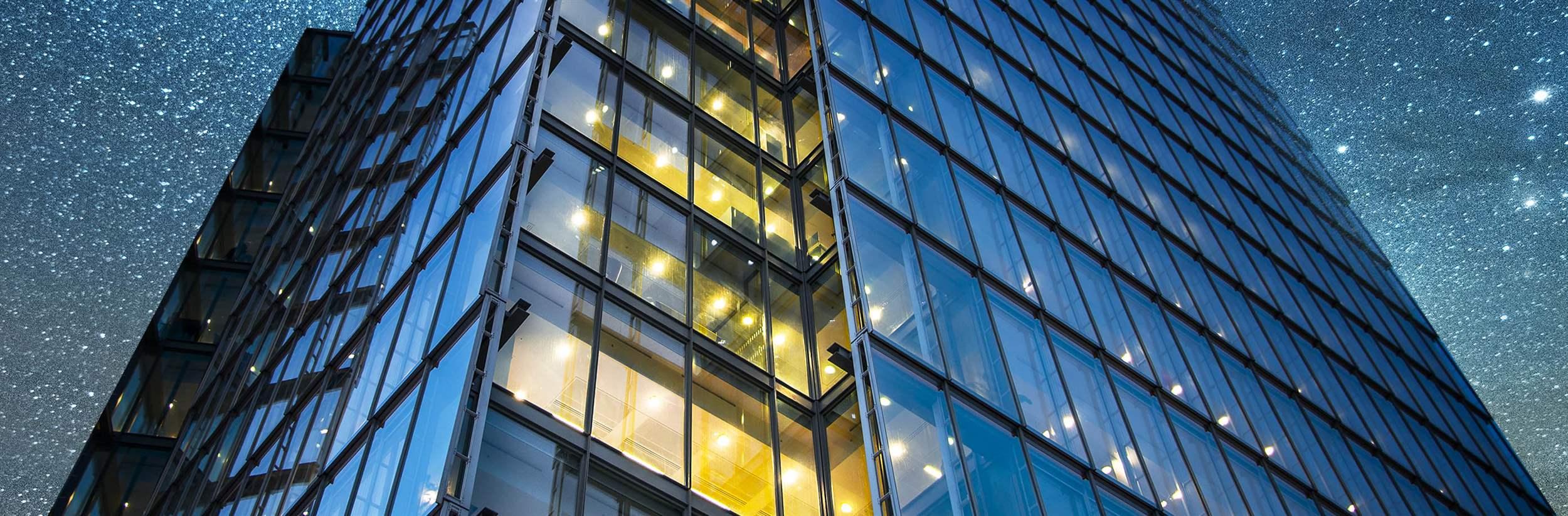 A beautiful office building at night. 