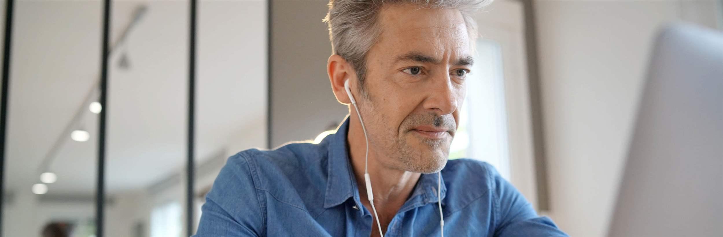 Mature man on video call working from home