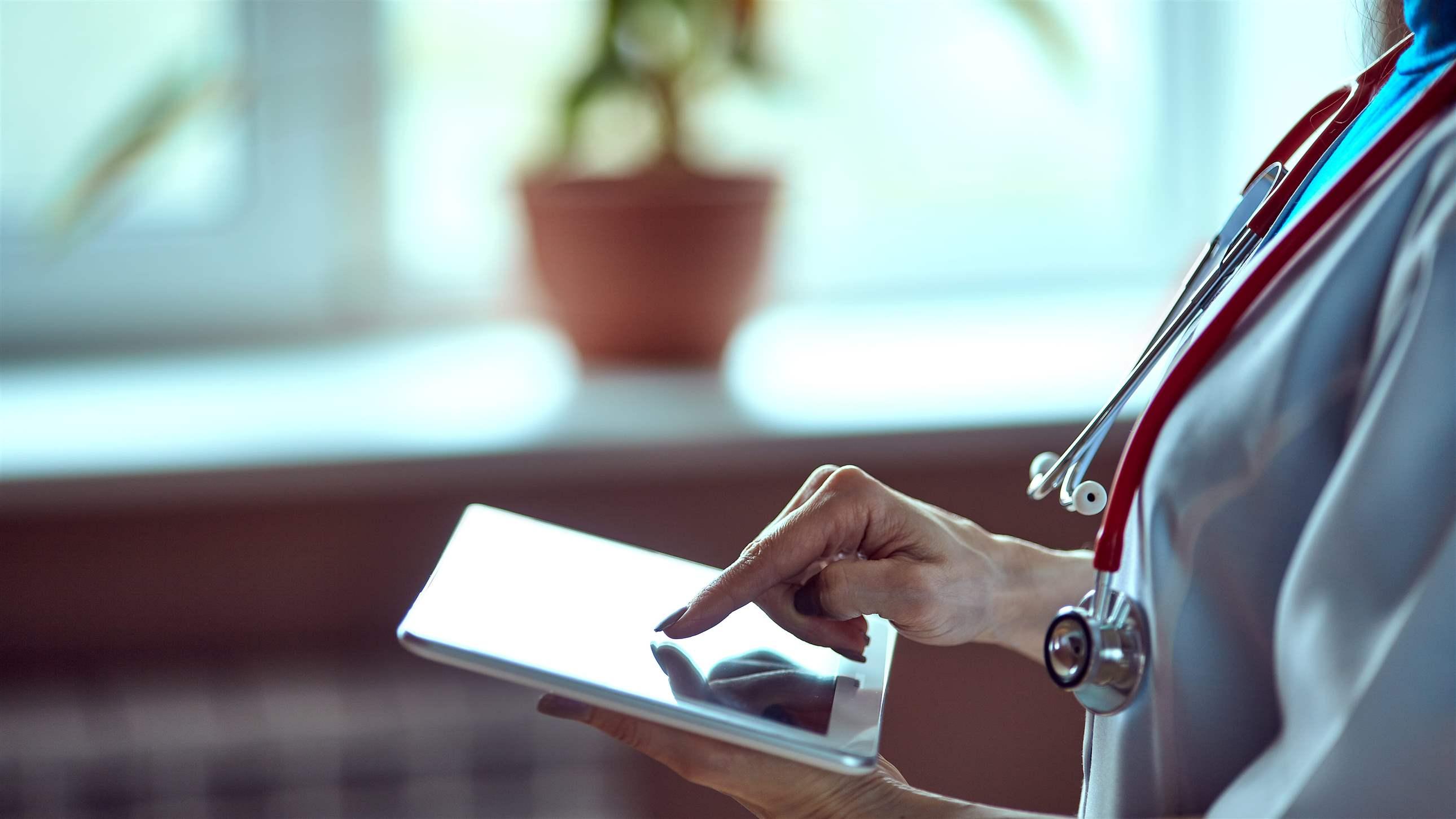 Medical professional using tablet