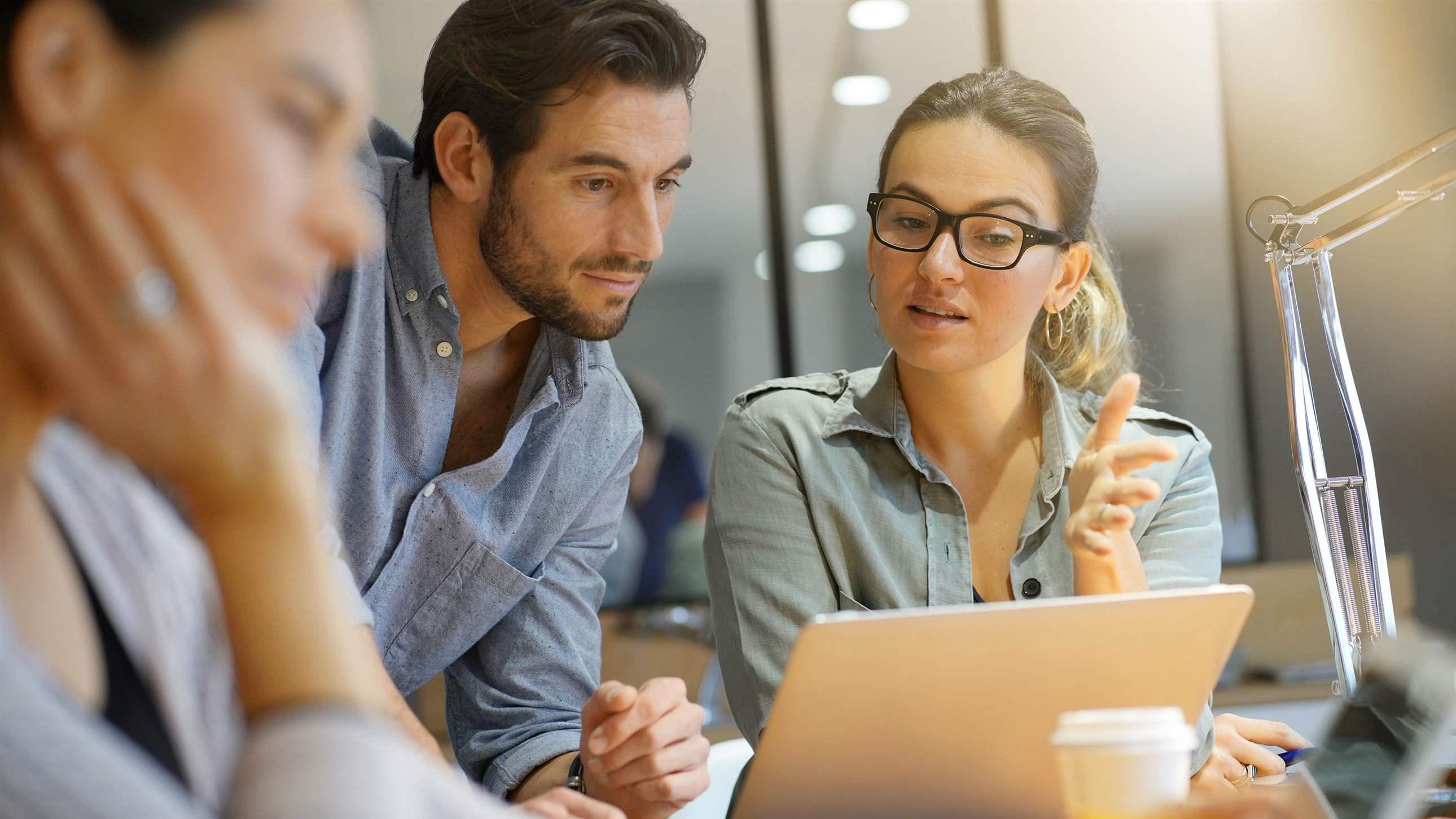 Colleagues workshopping business ideas in modern co working space