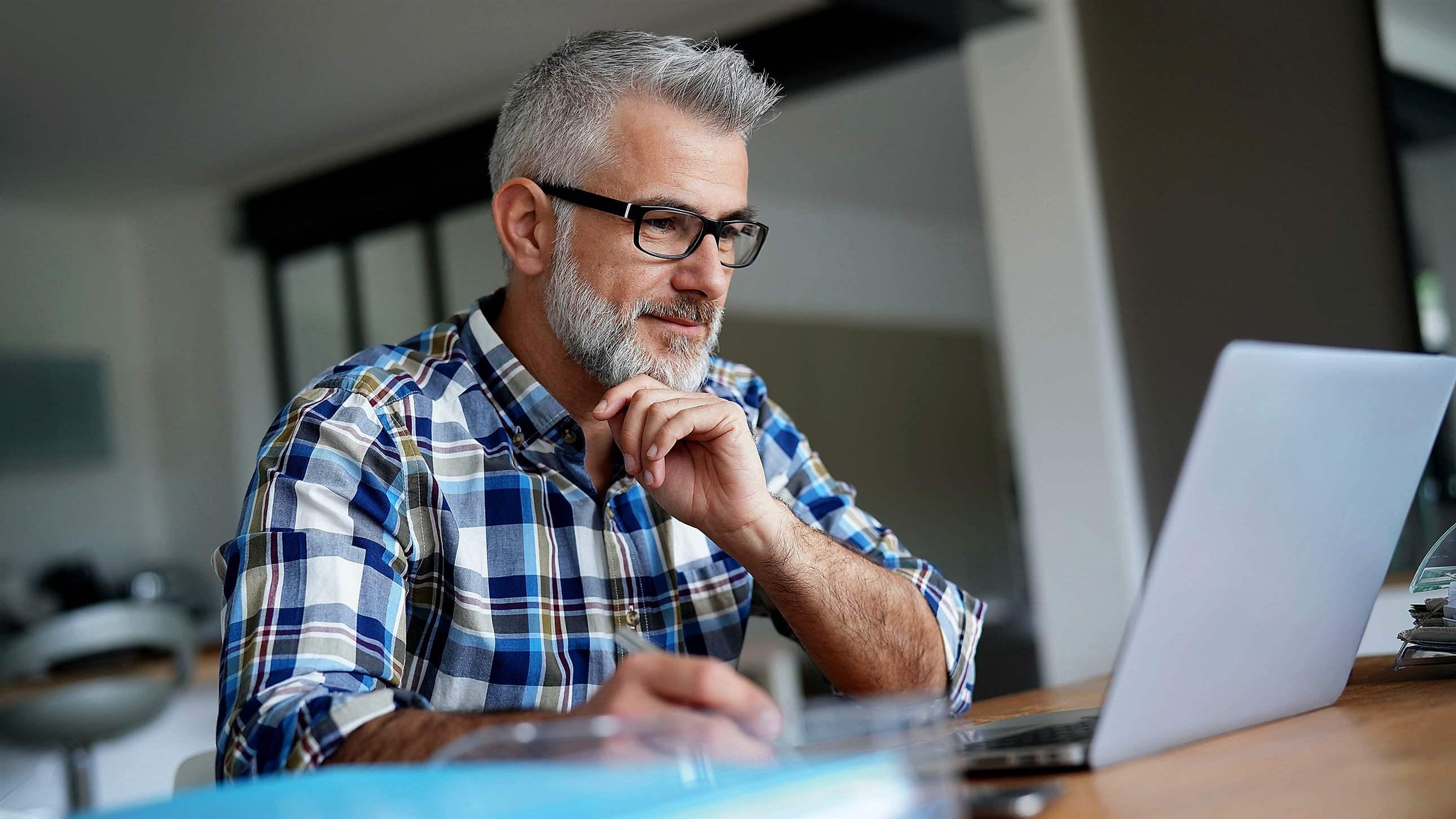 Man working from home on laptop computer