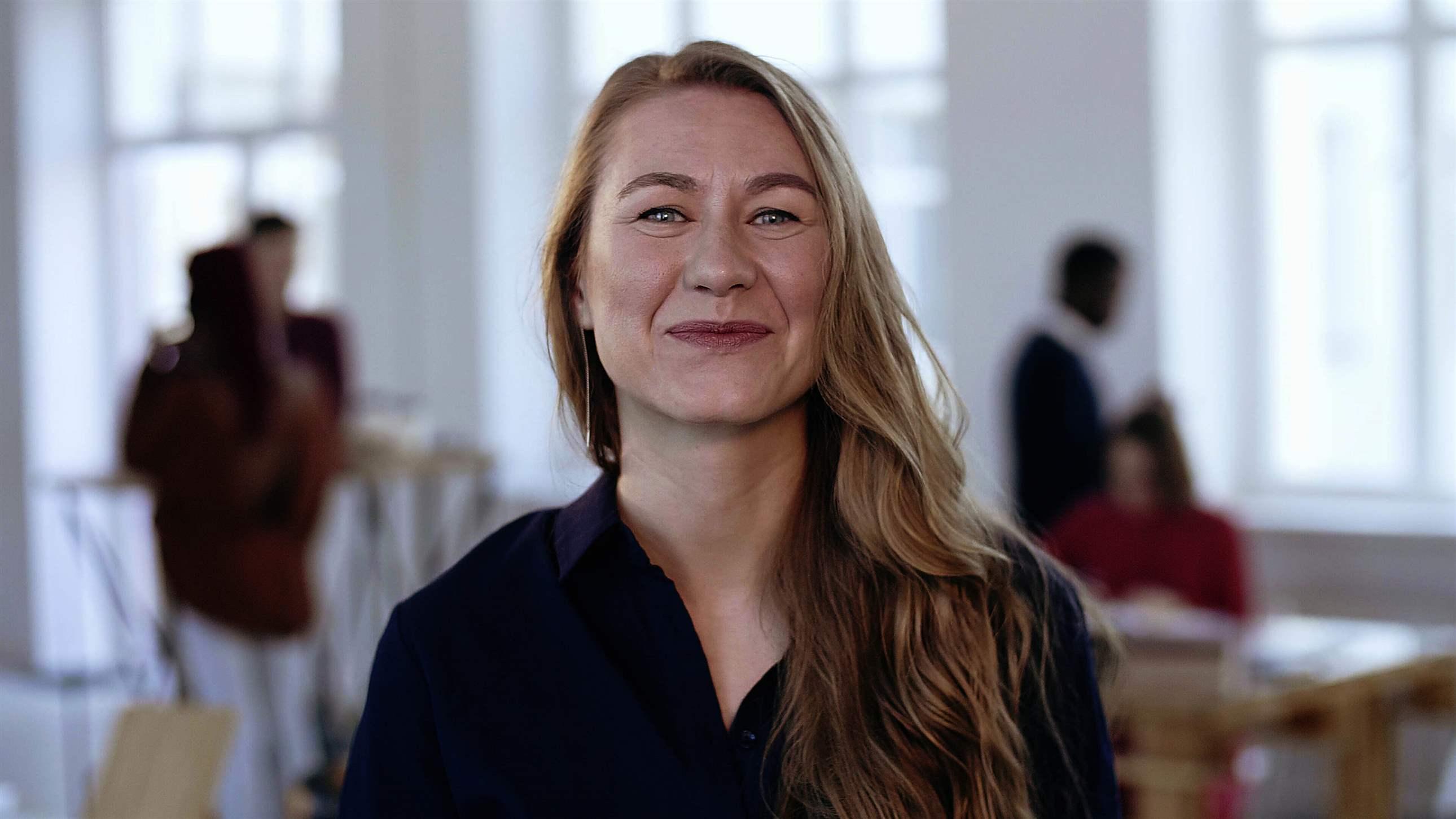 Portrait of happy young confident CEO business woman with blond hair in formal clothes looking at camera at office. Successful confident female sales professional at work, smiling cheerfully.