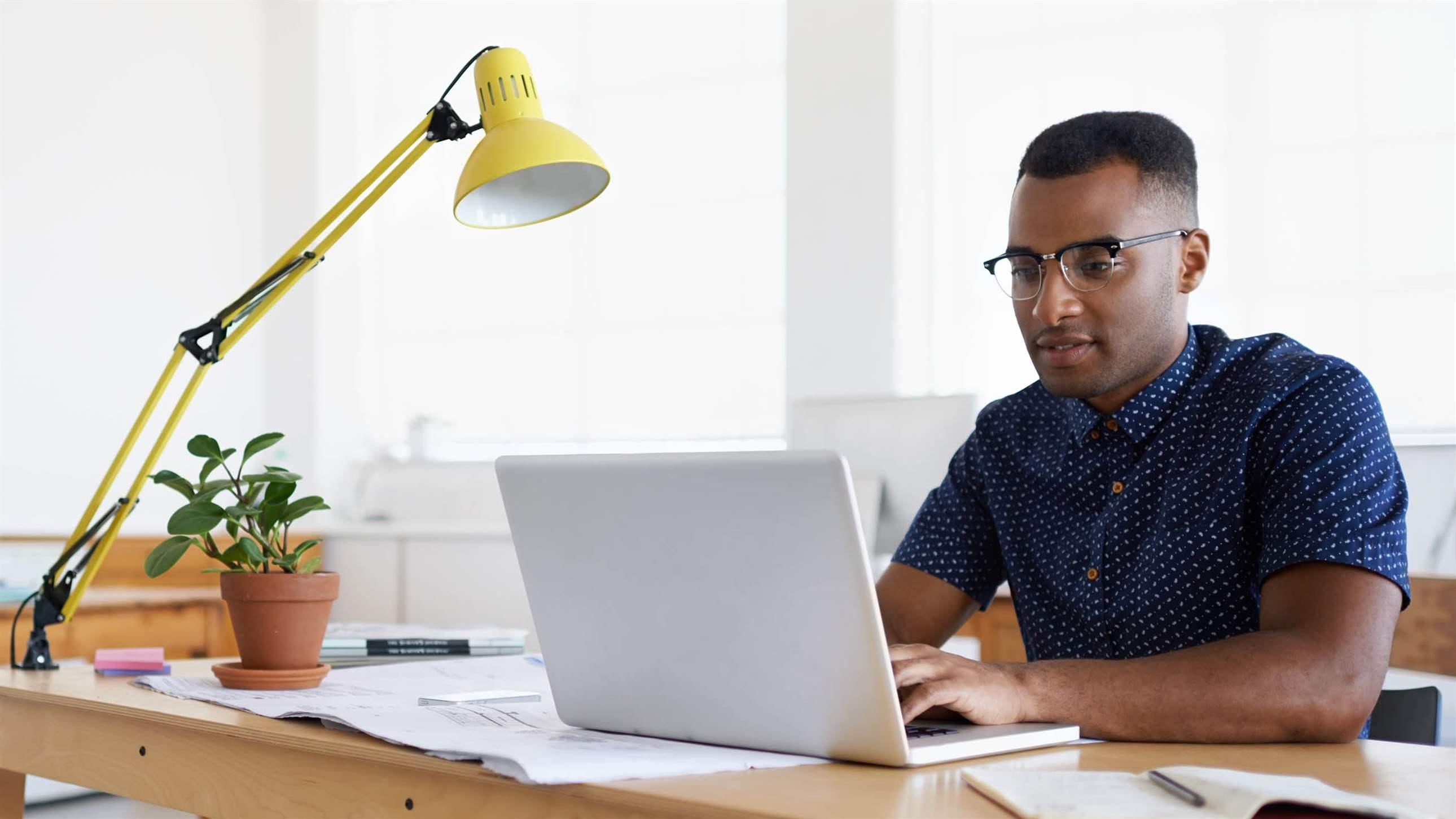 man working at his desk on laptop