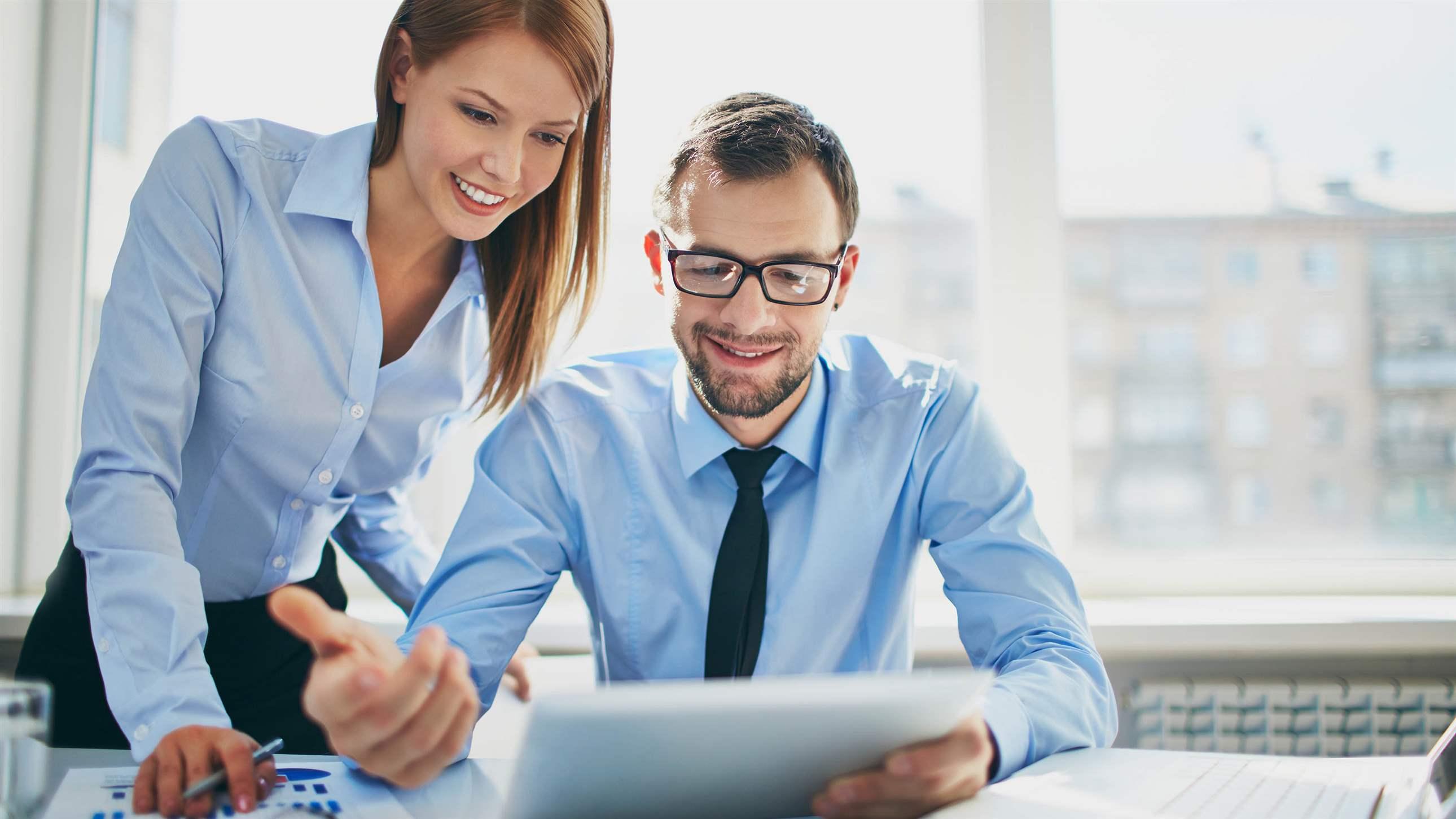 Image of two successful business partners working at meeting in office